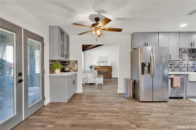 10634 Mesquite St, Oak Hills, CA 92344 - kitchen featuring decorative backsplash, appliances with stainless steel finishes, and gray cabinetry