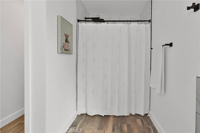 10634 Mesquite St, Oak Hills, CA 92344 - full bathroom with a shower with curtain, baseboards, and wood finished floors