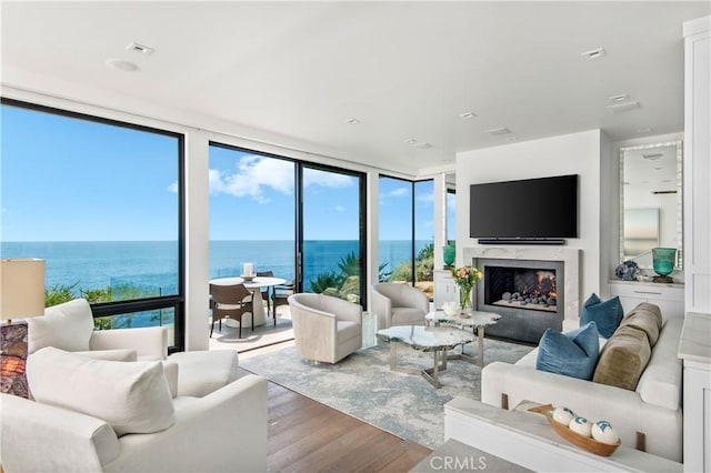 1715 Ocean Way, Laguna Beach, CA 92651 - living area with wood finished floors, a wall of windows, and a premium fireplace