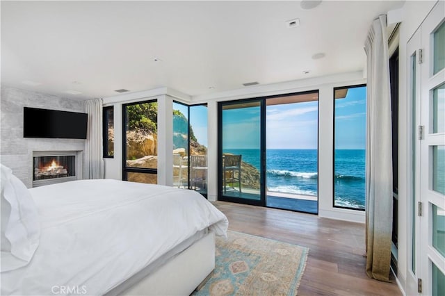 1715 Ocean Way, Laguna Beach, CA 92651 - bedroom with access to exterior, wood finished floors, a water view, and a fireplace