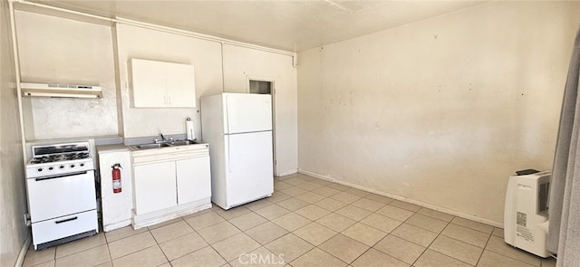 kitchen with white cabinets, white appliances, light countertops, light tile patterned floors, and under cabinet range hood