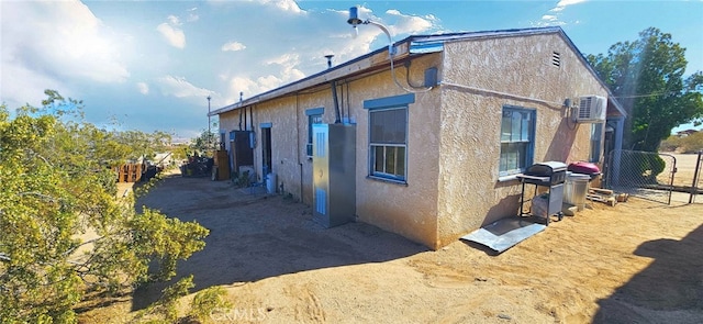 view of property exterior featuring fence and stucco siding