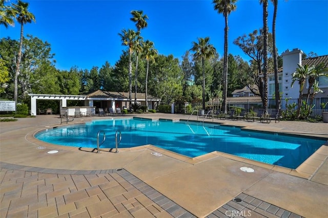 pool featuring a patio and fence