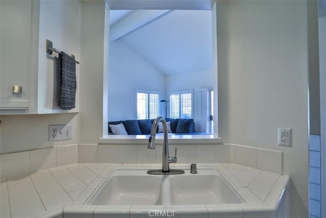 details with tile countertops and a sink