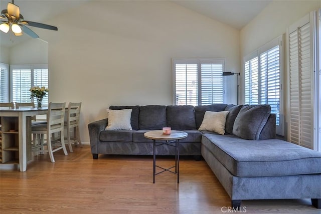 living room with high vaulted ceiling, ceiling fan, and wood finished floors
