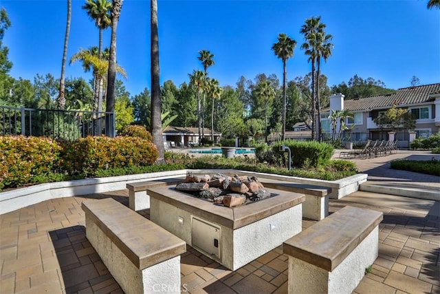 view of home's community featuring fence, a patio area, and a pool