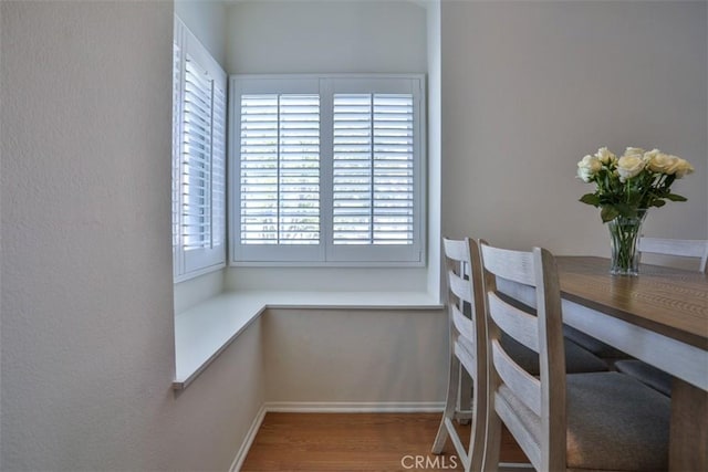 dining room featuring baseboards and wood finished floors
