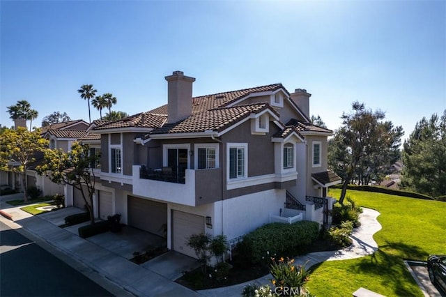 exterior space featuring stucco siding, a chimney, a tiled roof, concrete driveway, and an attached garage