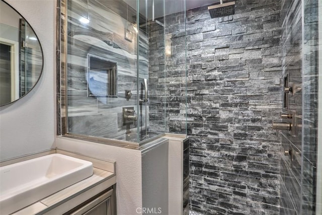 bathroom with vanity and a shower stall