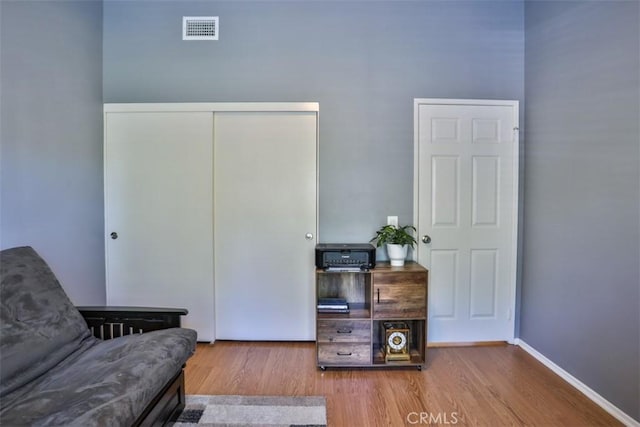 sitting room featuring baseboards, visible vents, and wood finished floors