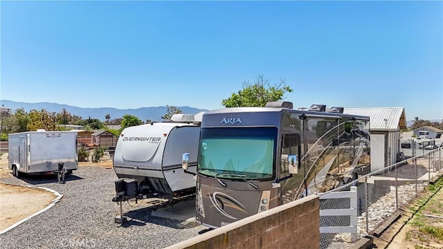 exterior space featuring fence and a mountain view