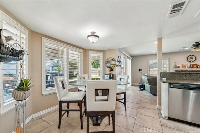 dining room featuring ceiling fan, a textured ceiling, visible vents, baseboards, and light tile patterned flooring