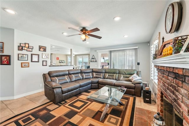 living room featuring recessed lighting, baseboards, ceiling fan, and a fireplace