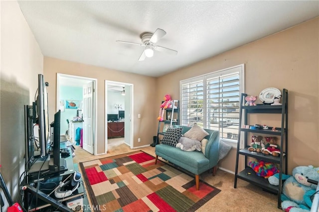 interior space featuring baseboards, carpet, and ceiling fan
