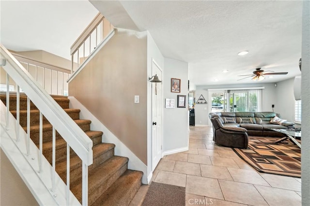 staircase featuring tile patterned flooring, a ceiling fan, baseboards, and recessed lighting