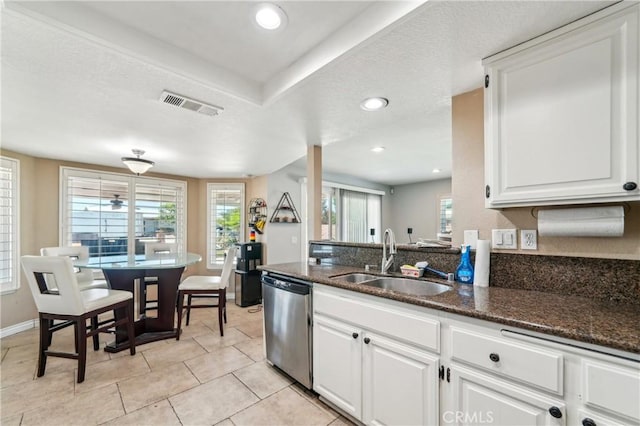 kitchen featuring white cabinets, a sink, recessed lighting, stainless steel dishwasher, and visible vents