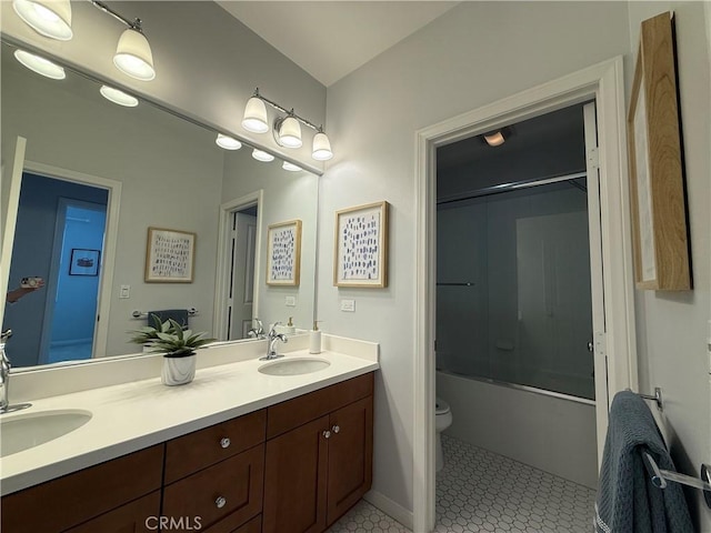 24 Flowerstalk, Irvine, CA 92618 - bathroom featuring double vanity, toilet, tile patterned floors, and combined bath / shower with glass door