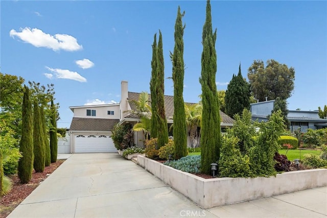 view of front of home featuring a garage, stucco siding, concrete driveway, and a tile roof