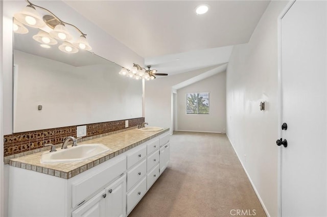 full bath with backsplash, double vanity, baseboards, and a sink
