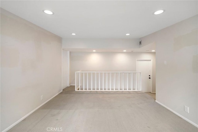 carpeted spare room with recessed lighting and baseboards