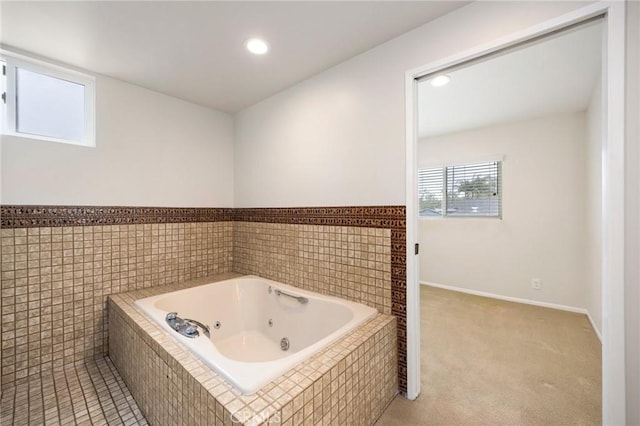 bathroom with recessed lighting and a jetted tub