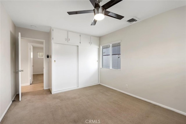 3822 S Cloverdale Ave, Los Angeles, CA 90008 - unfurnished bedroom with light colored carpet, baseboards, a closet, and a ceiling fan