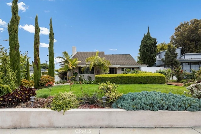 view of front of property with a chimney and a front yard