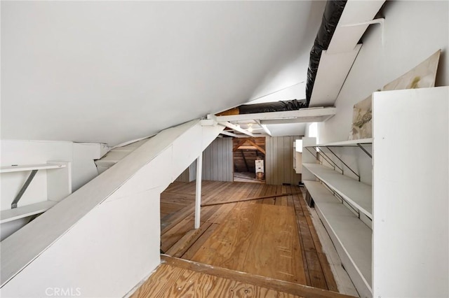 additional living space featuring hardwood / wood-style flooring and stairs