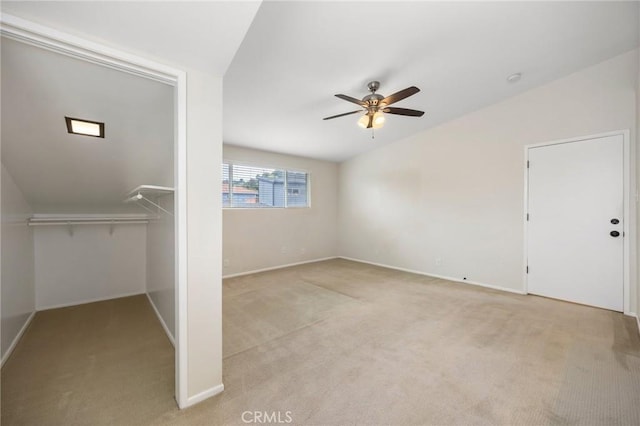 unfurnished bedroom with baseboards, ceiling fan, carpet, and lofted ceiling