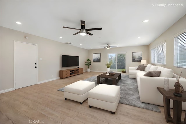 living area with recessed lighting, light wood-style flooring, ceiling fan, and baseboards