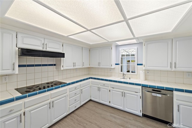 kitchen with light wood-style floors, white cabinetry, under cabinet range hood, a sink, and dishwasher