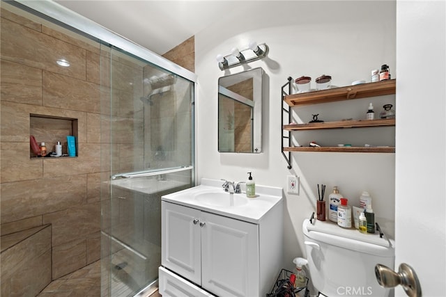 full bathroom with toilet, a shower stall, and vanity