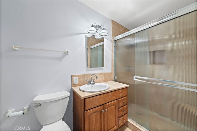 full bath with vanity, a stall shower, and toilet