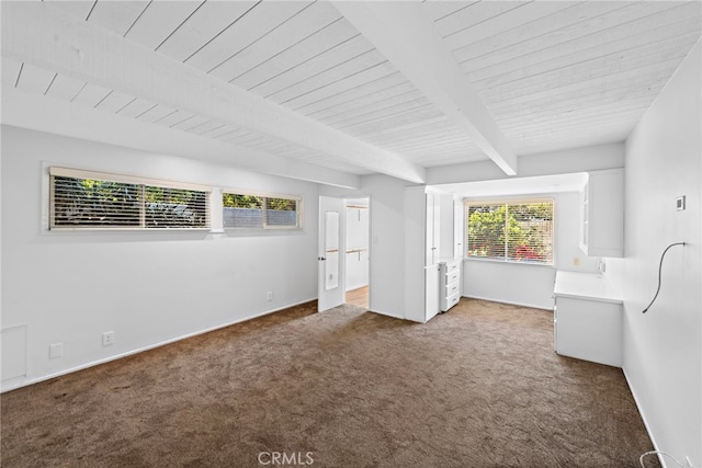 unfurnished bedroom featuring baseboards, beamed ceiling, wood ceiling, and light carpet