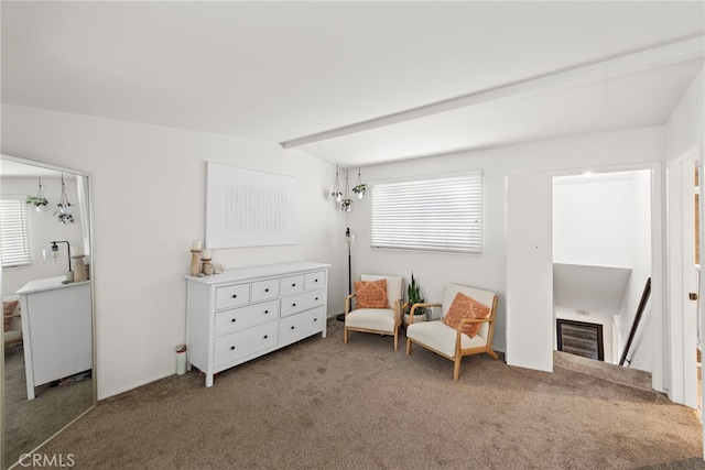sitting room with carpet flooring and an upstairs landing