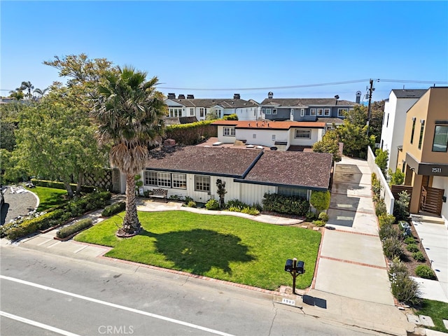 view of front of house featuring a residential view and a front lawn