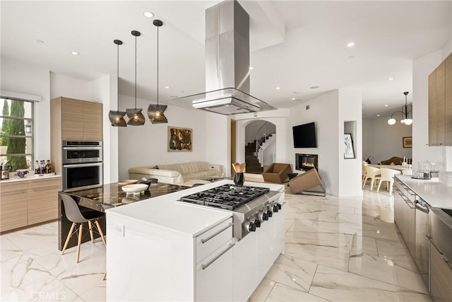 21 Alexa Ln, Ladera Ranch, CA 92694 - kitchen with modern cabinets, island exhaust hood, open floor plan, light marble finish flooring, and stainless steel appliances