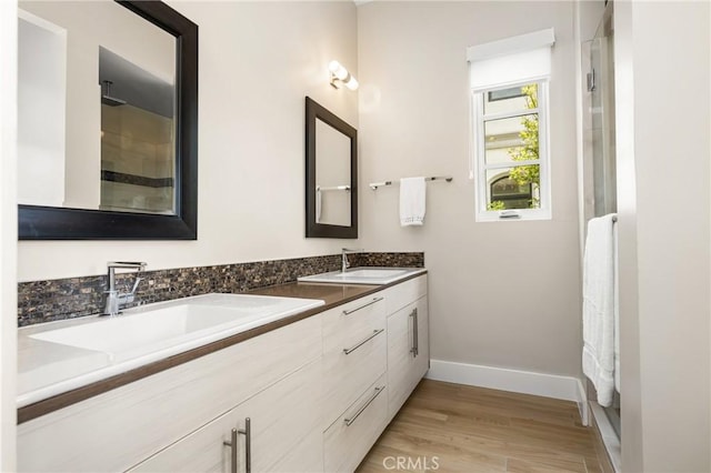 21 Alexa Ln, Ladera Ranch, CA 92694 - bathroom featuring double vanity, wood finished floors, and a shower