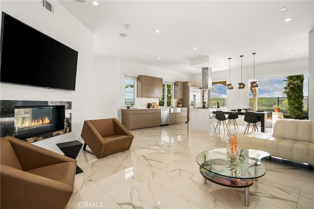 21 Alexa Ln, Ladera Ranch, CA 92694 - living area featuring light marble finish flooring, a multi sided fireplace, and recessed lighting