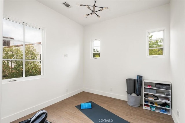21 Alexa Ln, Ladera Ranch, CA 92694 - workout room with wood finished floors, healthy amount of natural light, and a chandelier