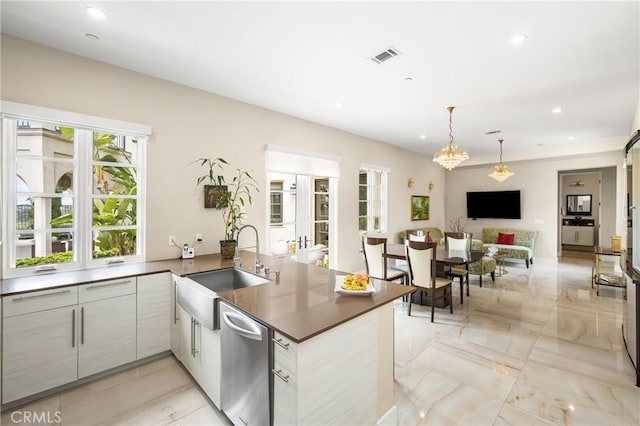 21 Alexa Ln, Ladera Ranch, CA 92694 - kitchen with stainless steel dishwasher, healthy amount of natural light, a peninsula, dark countertops, and recessed lighting