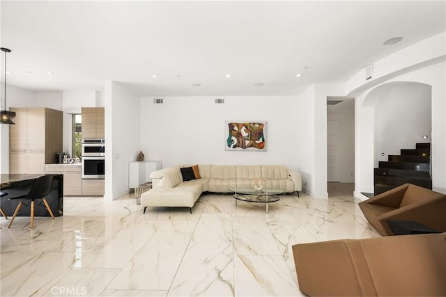 21 Alexa Ln, Ladera Ranch, CA 92694 - living room featuring recessed lighting, arched walkways, light marble finish flooring, and stairway
