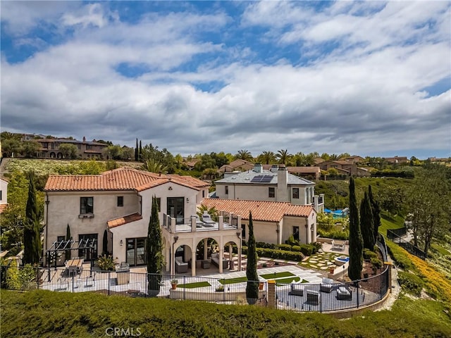 21 Alexa Ln, Ladera Ranch, CA 92694 - rear view of property with a balcony, a patio, a fenced backyard, stucco siding, and a tiled roof