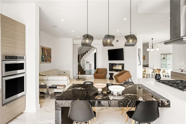 21 Alexa Ln, Ladera Ranch, CA 92694 - living area with light marble finish floors, recessed lighting, a glass covered fireplace, and a chandelier