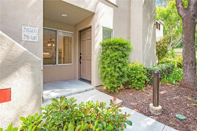 view of exterior entry featuring stucco siding