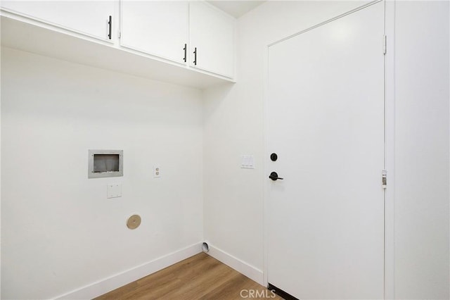 laundry area with cabinet space, baseboards, hookup for a washing machine, and light wood-type flooring