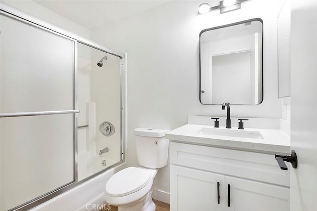 full bath with vanity, enclosed tub / shower combo, and toilet