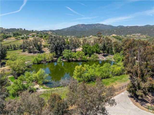 drone / aerial view with a water and mountain view