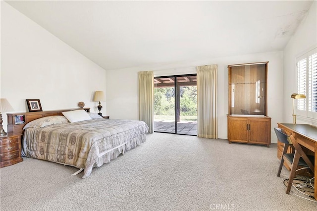 bedroom with access to outside, carpet, and lofted ceiling