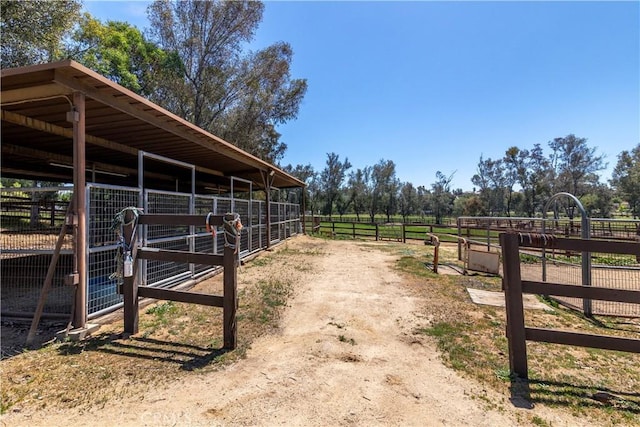 view of stable featuring a rural view